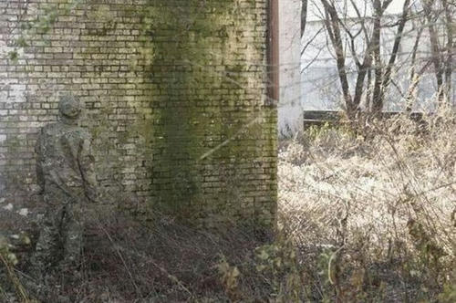camo-in-front-of-the-wall.jpg